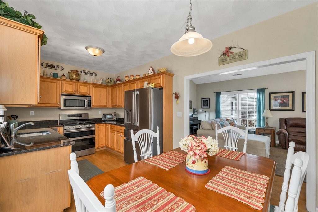 401 Autumn Ridge Drive, Unit 401 Ayer, MA 01432 - Photo 13 of 33 a kitchen with stainless steel appliances granite countertop a stove and refrigerator