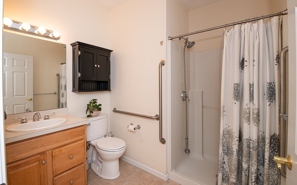 401 Autumn Ridge Drive, Unit 401 Ayer, MA 01432 - Photo 16 of 33 a bathroom with a granite countertop sink toilet and shower