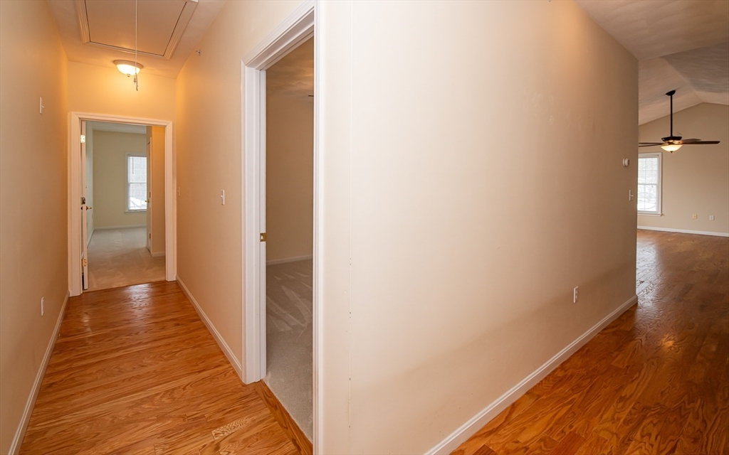 401 Autumn Ridge Drive, Unit 401 Ayer, MA 01432 - Photo 17 of 33 a view of a hallway with wooden floor