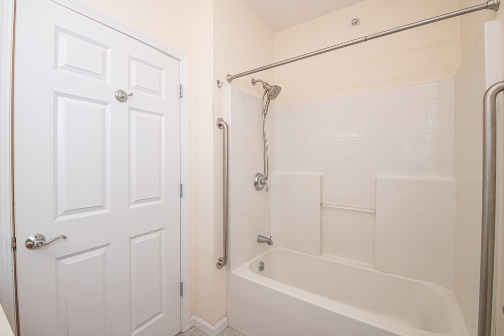 401 Autumn Ridge Drive, Unit 401 Ayer, MA 01432 - Photo 23 of 33 a bathroom with a shower and a bath tub