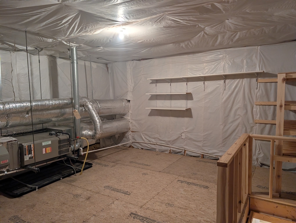 401 Autumn Ridge Drive, Unit 401 Ayer, MA 01432 - Photo 28 of 33 a room with water heater and racks