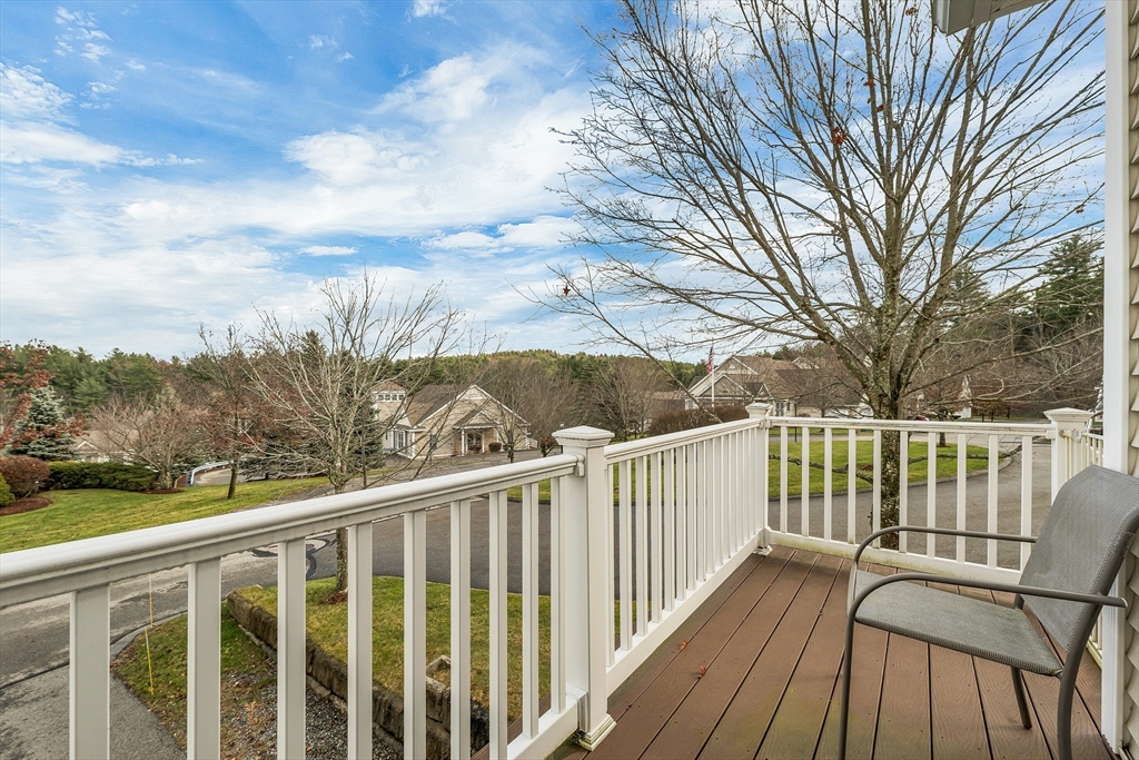 401 Autumn Ridge Drive, Unit 401 Ayer, MA 01432 - Photo 4 of 33 a view of a balcony with wooden fence