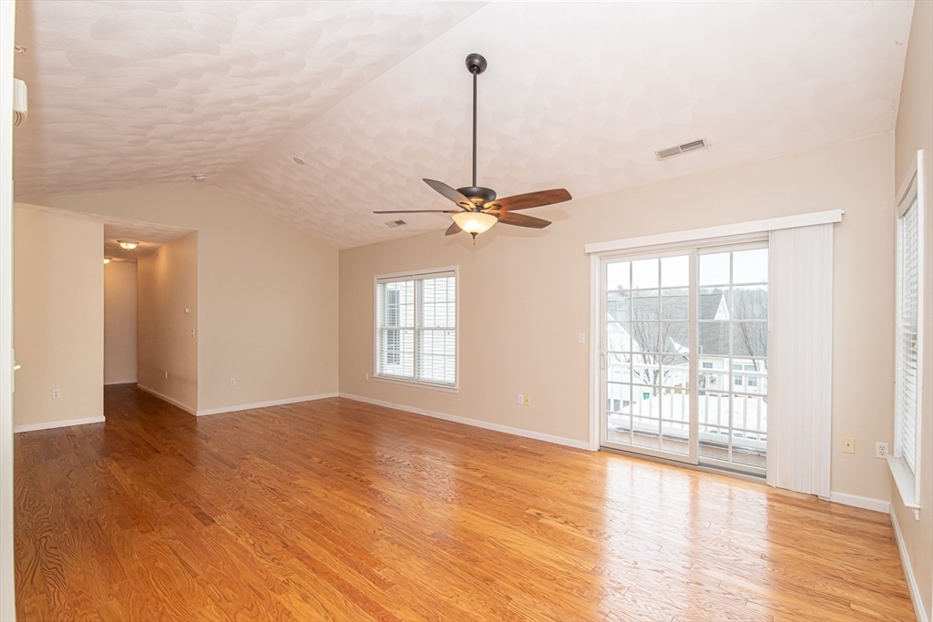 401 Autumn Ridge Drive, Unit 401 Ayer, MA 01432 - Photo 7 of 33 a view of a room with window wooden floor and a chandelier