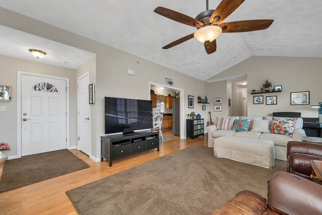 401 Autumn Ridge Drive, Unit 401 Ayer, MA 01432 - Photo 8 of 33 a living room with furniture and a flat screen tv
