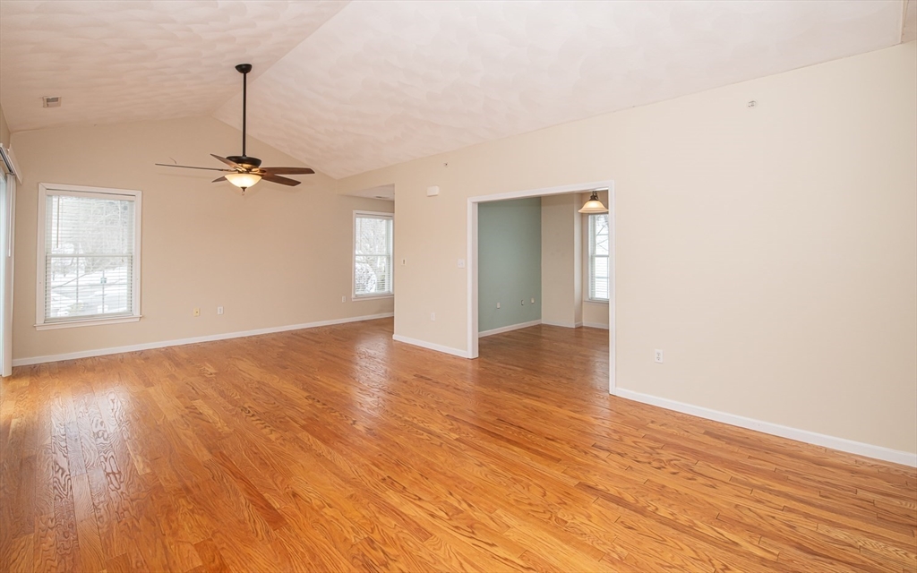 401 Autumn Ridge Drive, Unit 401 Ayer, MA 01432 - Photo 10 of 33 wooden floor in an empty room with a window