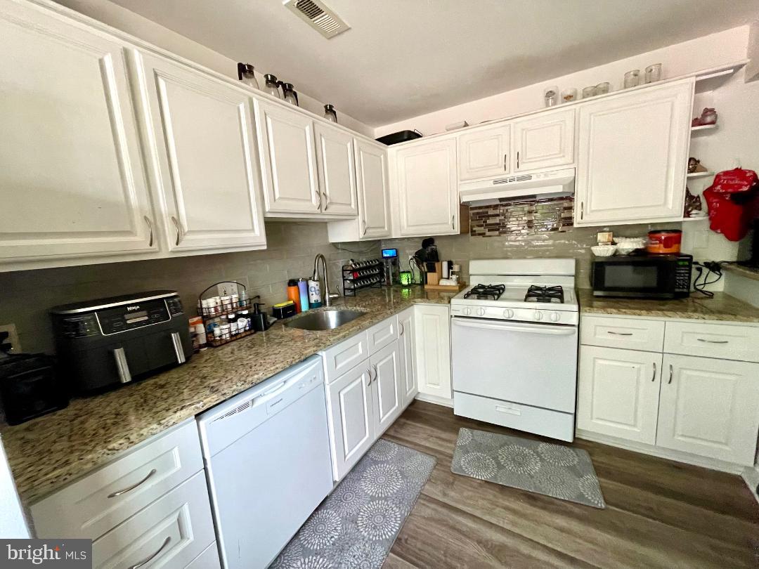 904-906 Main Avenue Croydon, PA 19021 - Photo 8 of 51 a kitchen with white cabinets and white appliances