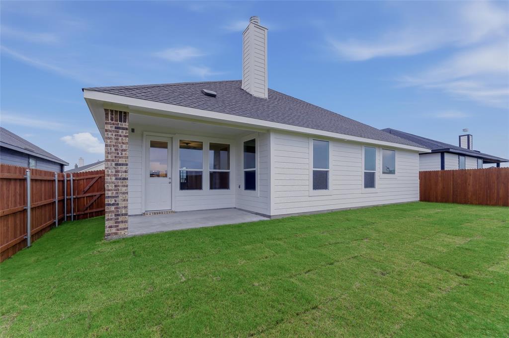 1329 Frio Drive Springtown, TX 76082 - Photo 22 of 25 Expansive backyard with a covered concrete patio, new sod, and privacy fencing