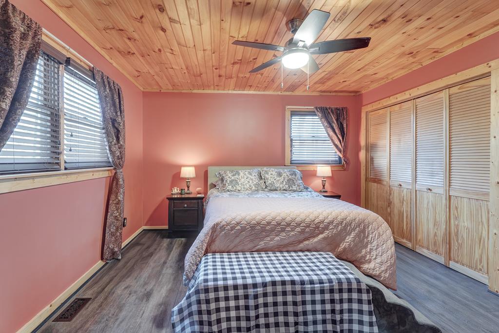 388 Cozy Cove Road Blairsville, GA 30512 - Photo 15 of 44 a bedroom with a bed and wooden floor