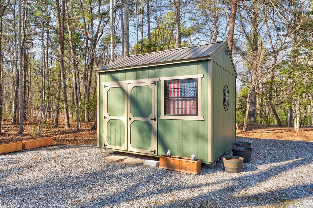 388 Cozy Cove Road Blairsville, GA 30512 - Photo 35 of 44 a view of a wooden house with large windows