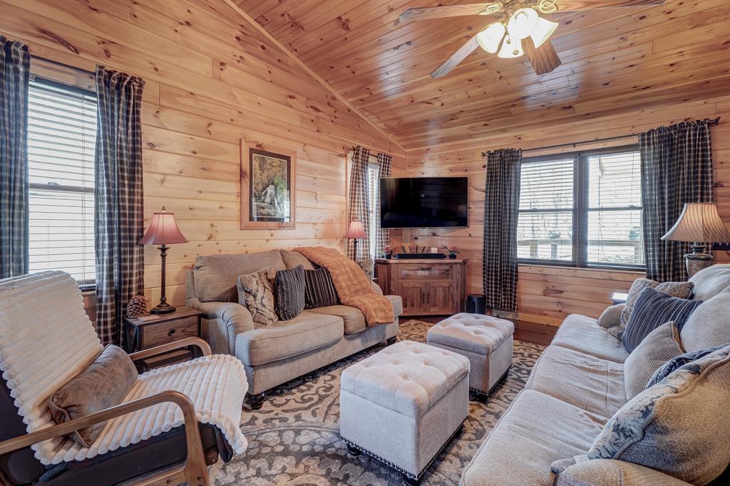 388 Cozy Cove Road Blairsville, GA 30512 - Photo 4 of 44 a living room with furniture a flat screen tv and a large window