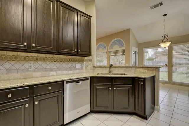 a kitchen with a sink and cabinets
