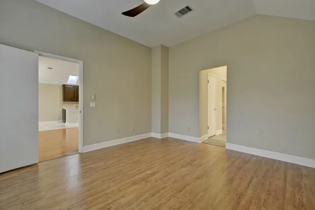 a view of an empty room and wooden floor