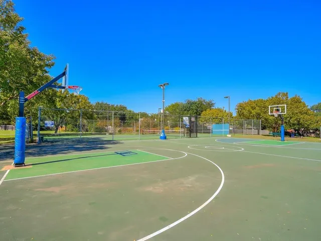a view of a playground with basketball court