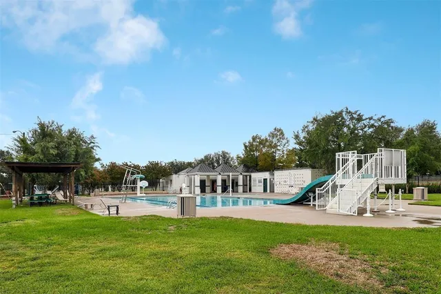 a view of a house with swimming pool and a yard