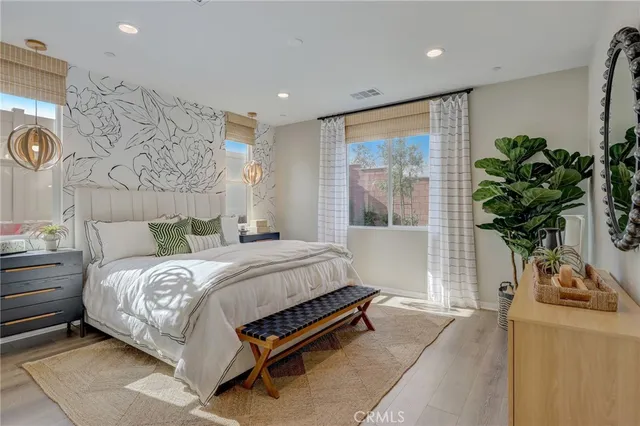 a bedroom with a bed and a wall painting