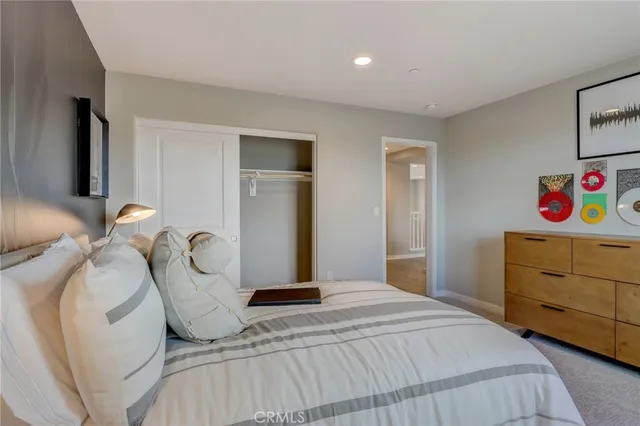 a bedroom with a bed and a painting on the wall