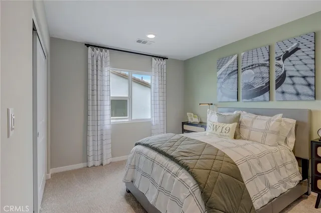 a bedroom with a bed and cabinet