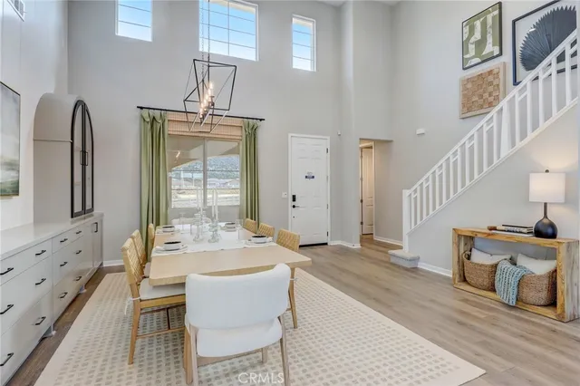 a living room with furniture a fireplace and a chandelier