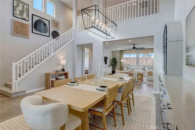 a view of a dining room with furniture a chandelier and wooden floor