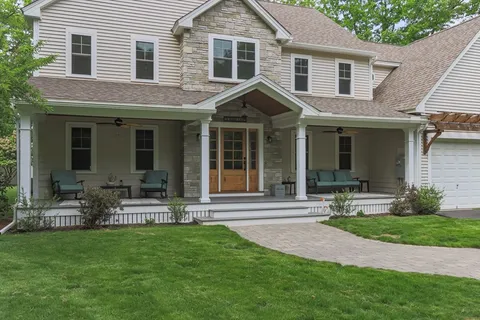 a front view of a house with garden and porch