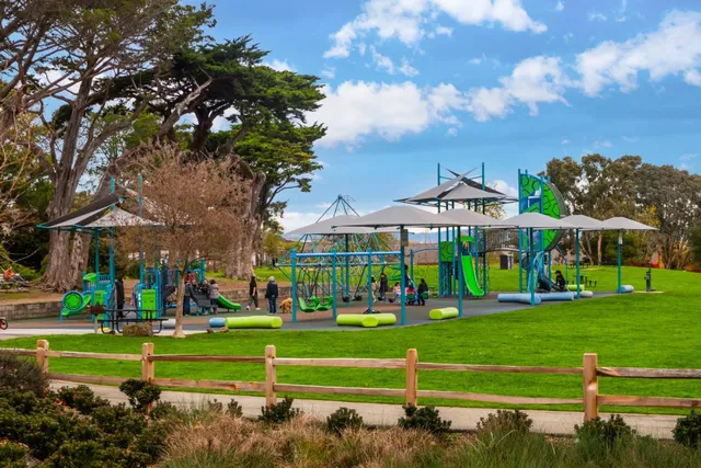 a view of a yard with wooden fence