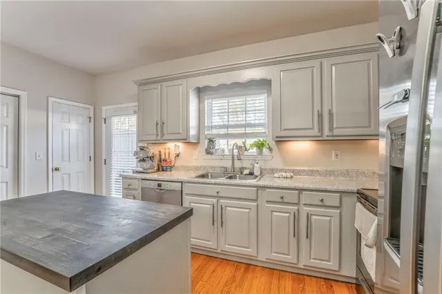 a kitchen with granite countertop a sink and cabinets