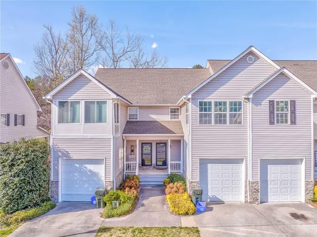 an aerial view of a house with a yard and garden