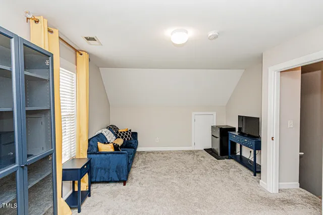 a living room with furniture and kitchen view