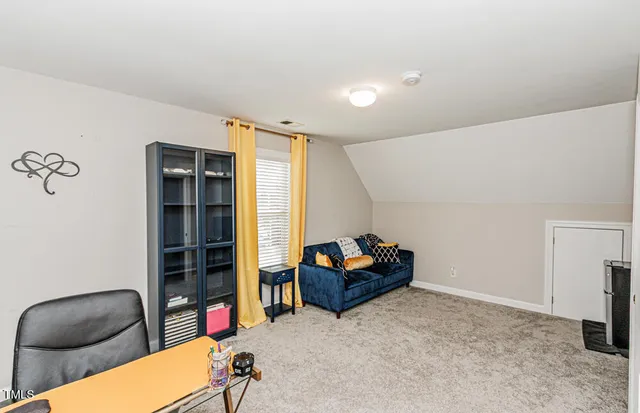 a livingroom with workspace and a couch