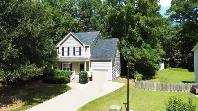 a front view of a house with a yard table and chairs