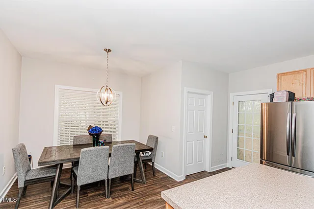 a view of a dining room with furniture and a chandelier
