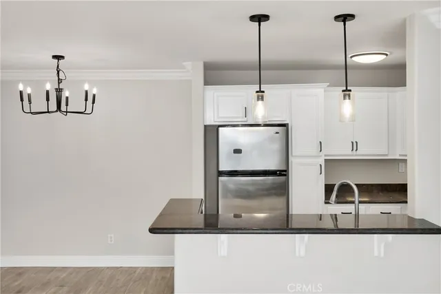 a kitchen with stainless steel appliances granite countertop a sink a refrigerator and a stove