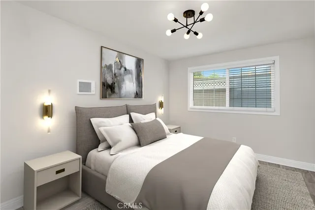 a bedroom with a bed and a painting on the wall