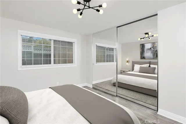 a bedroom with a bed and glass window