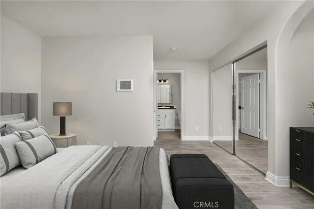 a bedroom with a bed and a lamp on table