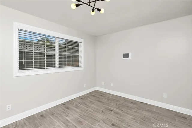 a view of a room with wooden floor and windows