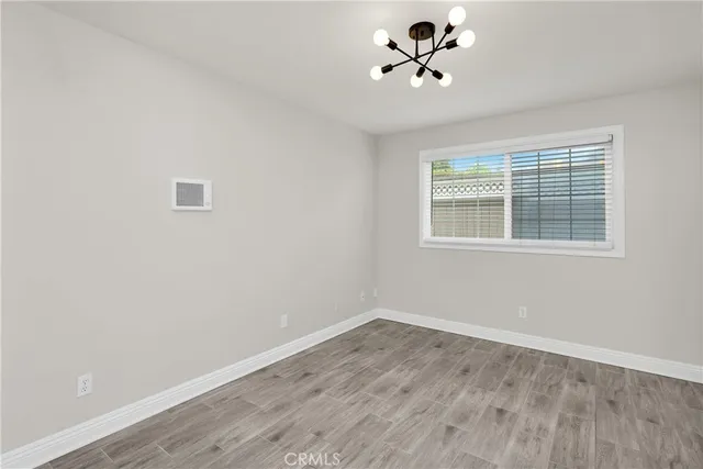 a view of a room with wooden floor and windows