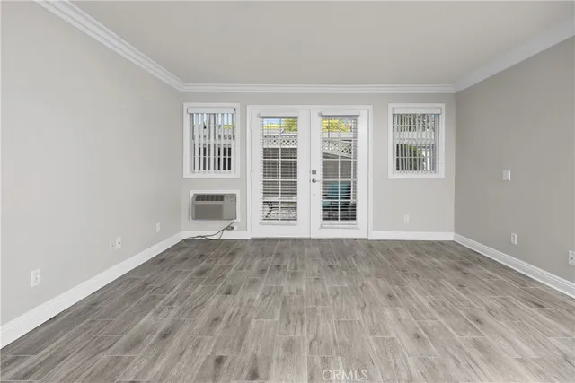 an empty room with closet and wooden floor
