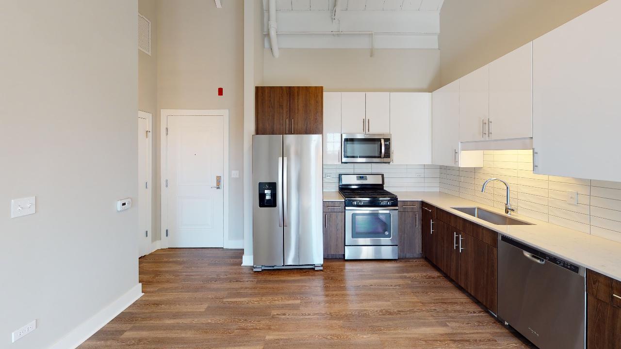 Undisclosed Address Chicago, IL 60640 - Photo 5 of 9 a kitchen with stainless steel appliances granite countertop a refrigerator a stove top oven a sink and dishwasher