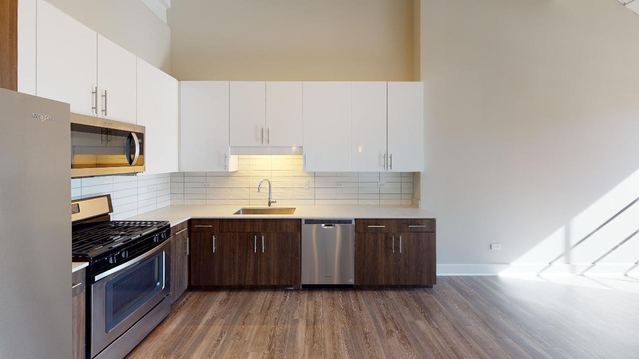 Undisclosed Address Chicago, IL 60640 - Photo 6 of 9 a kitchen with stainless steel appliances granite countertop a stove a sink and a microwave