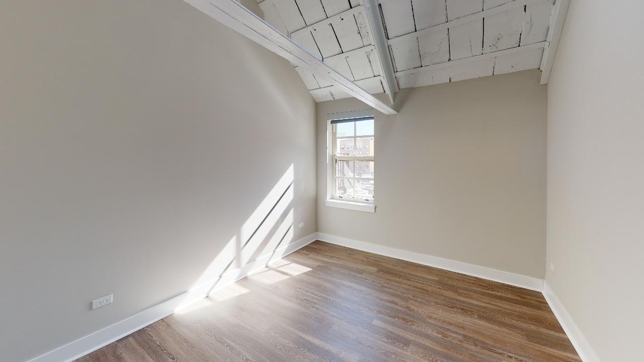 Undisclosed Address Chicago, IL 60640 - Photo 7 of 9 an empty room with wooden floor and windows