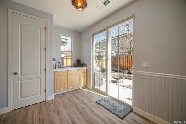 a open kitchen with white cabinets and wooden floor