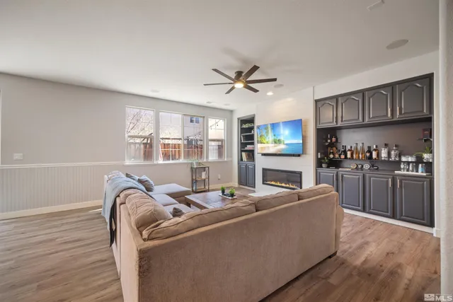 a living room with furniture a window and kitchen view