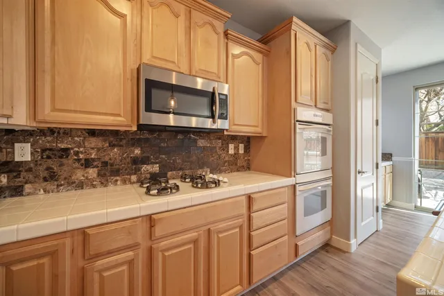 a kitchen with stainless steel appliances white cabinets and a sink