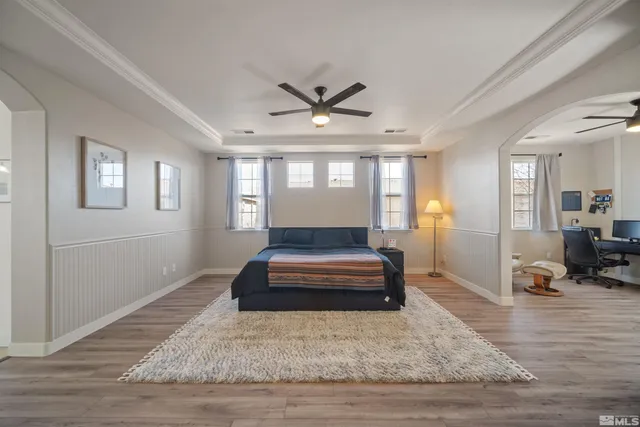 a living room with a couch and wooden floor