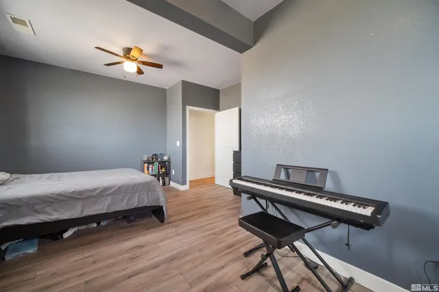 a bedroom with bed and a chandelier