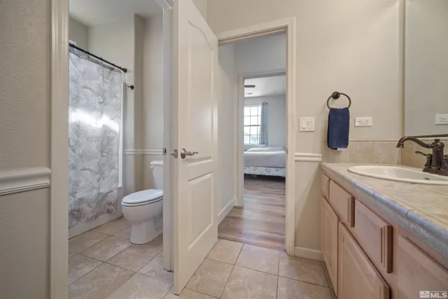a spacious bathroom with a toilet sink and shower