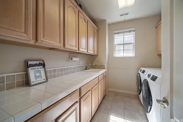 a view of a kitchen with fridge and washer