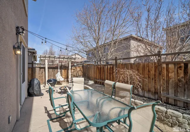 a view of a patio with couches table and chairs and wooden floor