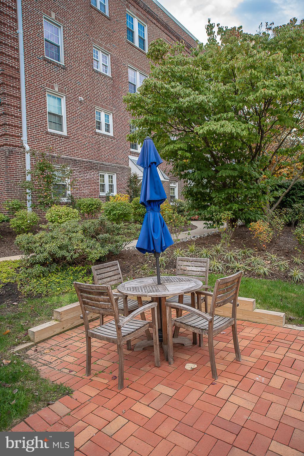 104 Woodside Road, Unit B201 Haverford, PA 19041 - Photo 32 of 32 Patio Tables Next to Community Pool